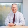 Martyn Evans, Chair of the SPA sitting at a desk inside an office building.